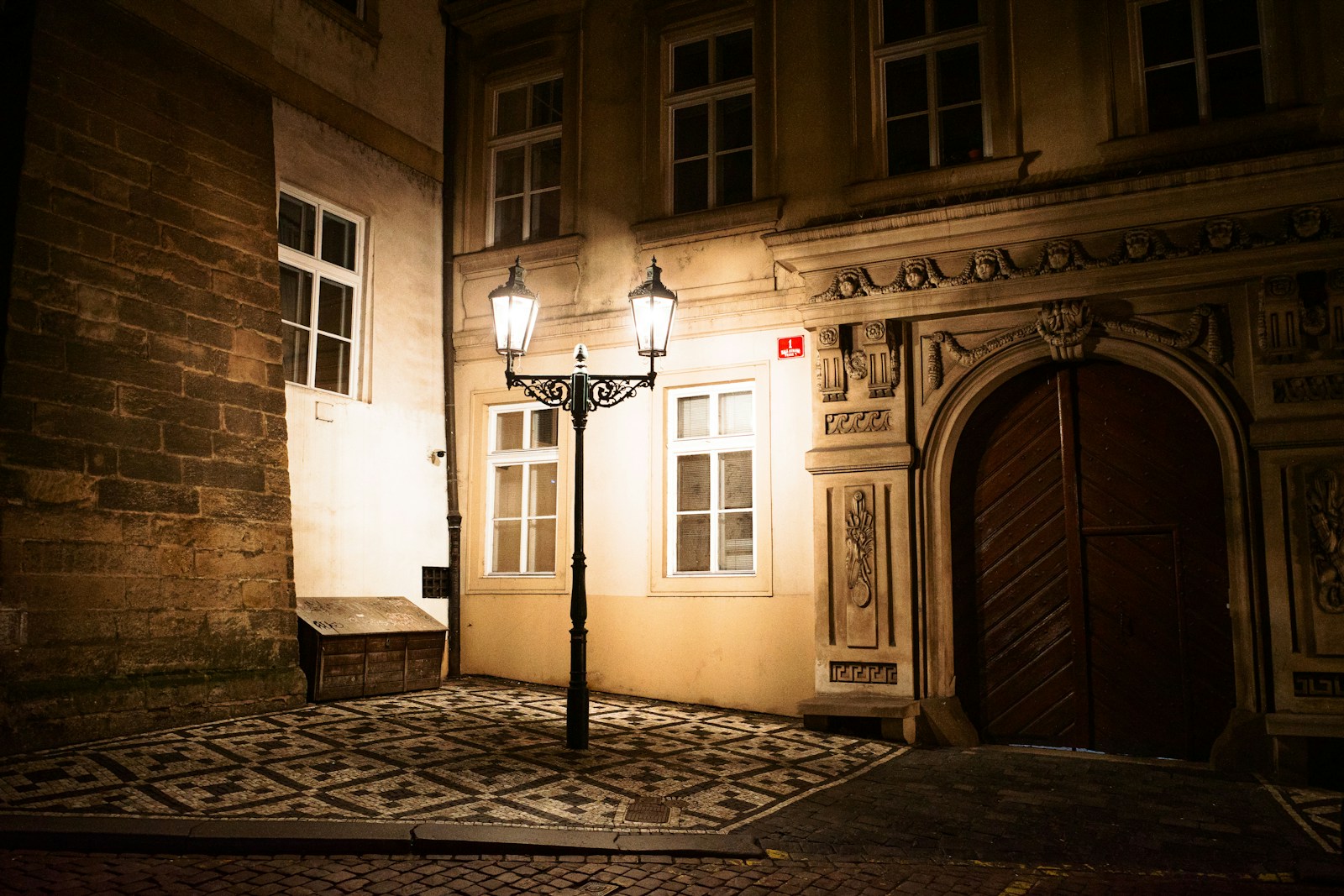 A street light in front of a building at night